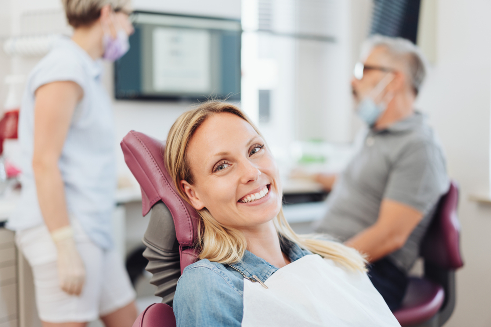 woman sitting in dental chair smiling